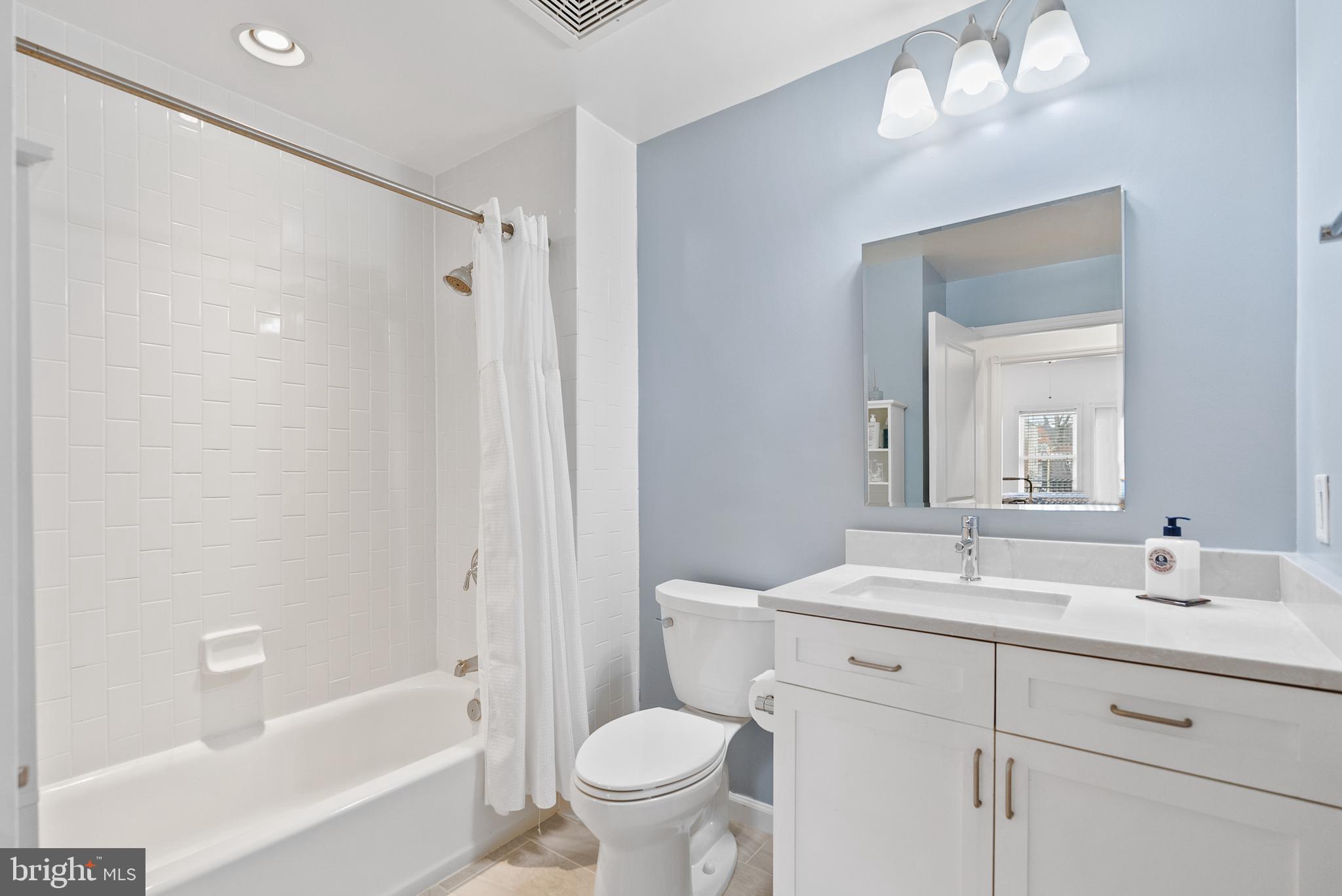 401 13th Street Northeast, Unit 313 Washington, DC 20002 - Photo 33 of 45 a bathroom with a sink a toilet and a bathtub
