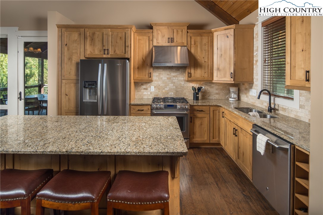 1253 Goldenrod Road Boone, NC 28607 - Photo 7 of 48 a kitchen with kitchen island a sink table and chairs