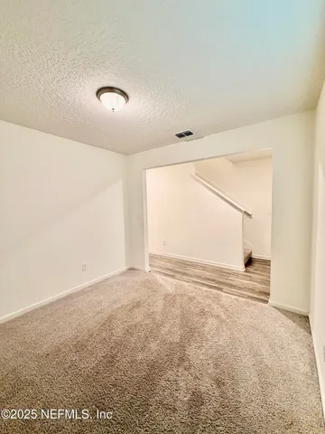 an empty room with a empty space and windows