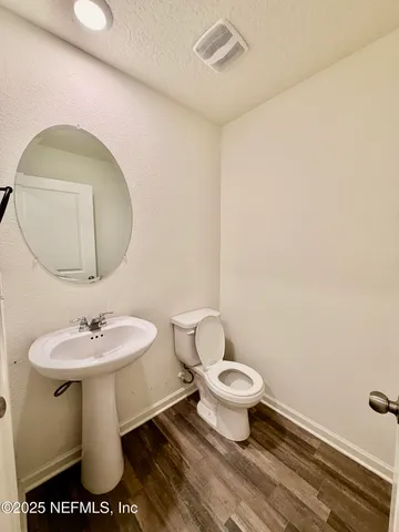 a bathroom with a sink toilet and a mirror