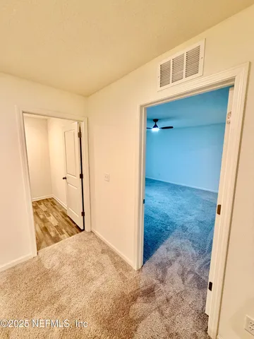 a view of a big room with closet and mirror