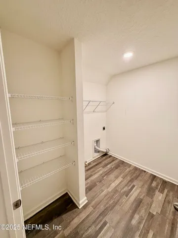 a view of storage and utility room with empty racks