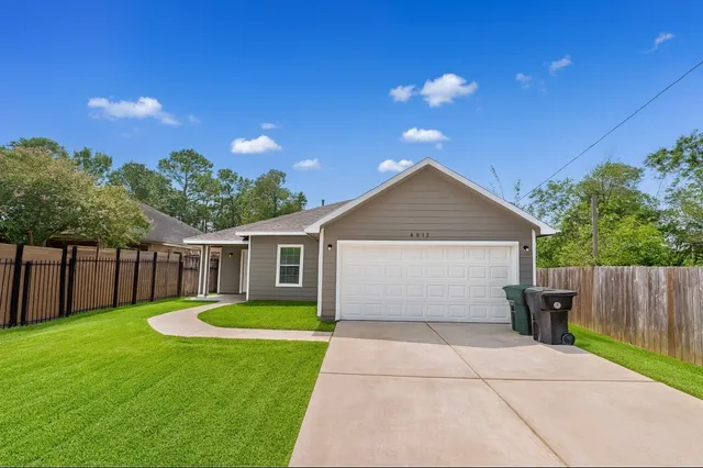 a view of a house with a yard and a garden