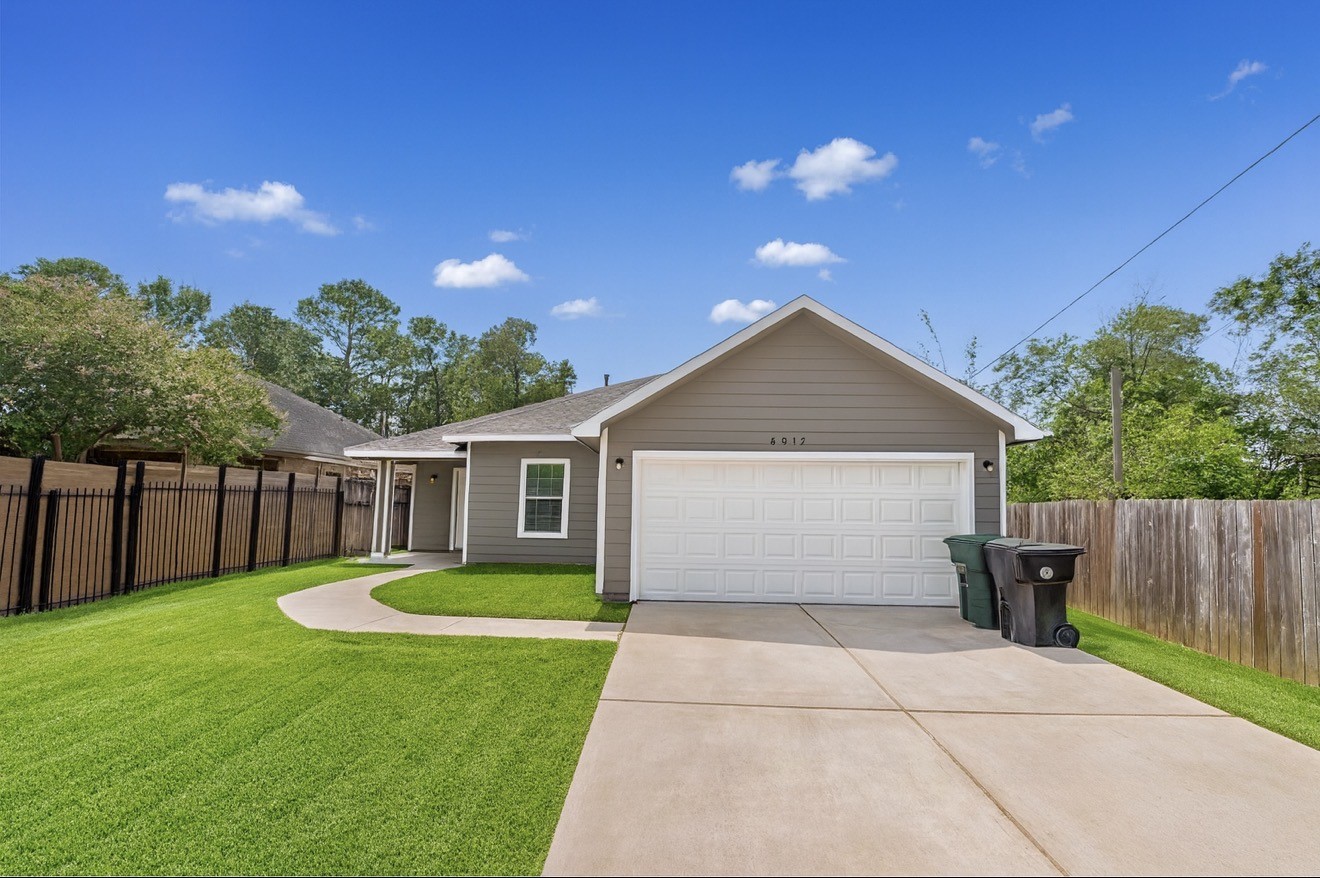 6017 East Houston Road Houston, TX 77028 - Photo 1 of 13 a view of a house with a yard and a garden