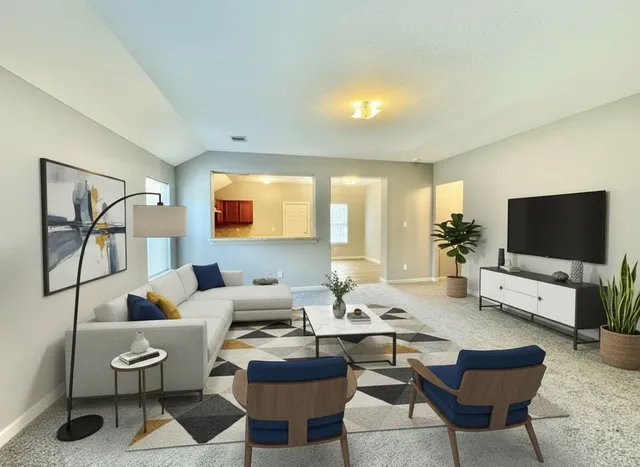 a living room with furniture and a flat screen tv