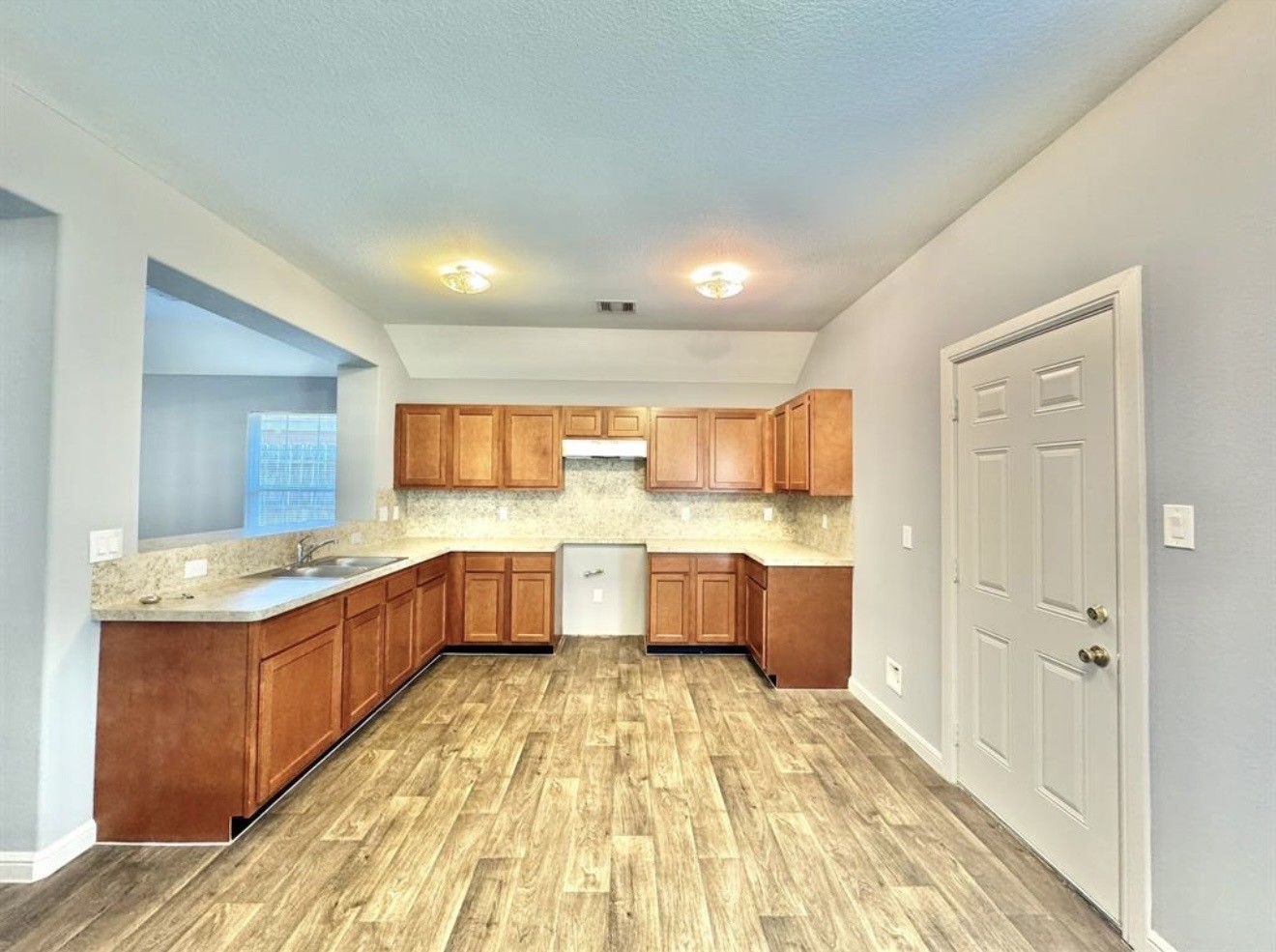 6017 East Houston Road Houston, TX 77028 - Photo 4 of 13 a large kitchen with stainless steel appliances kitchen island granite countertop a sink and cabinets