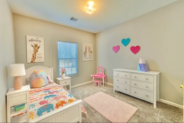 a bedroom with bed and a couch