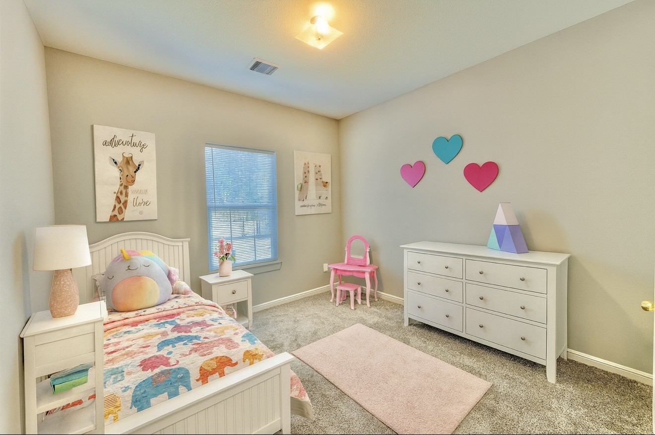 6017 East Houston Road Houston, TX 77028 - Photo 9 of 13 a bedroom with a bed and furniture