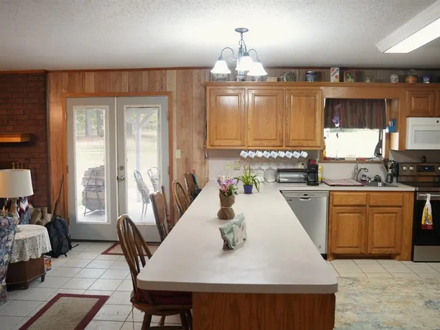 a kitchen with stainless steel appliances a sink cabinets and a counter top space