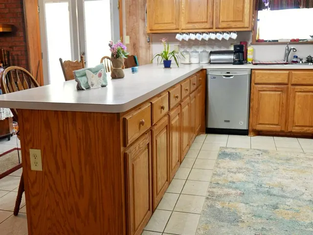 a kitchen with stainless steel appliances granite countertop a refrigerator and a stove