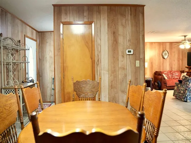a view of a dining room with furniture and chandelier