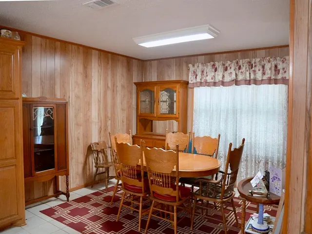 a dining room with furniture and window