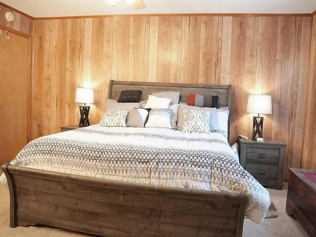 a bedroom with a bed and a chandelier