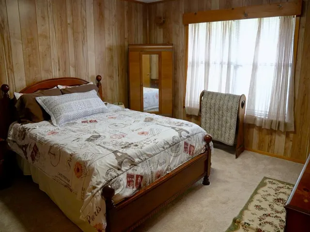 a bathroom with a granite countertop sink toilet and mirror