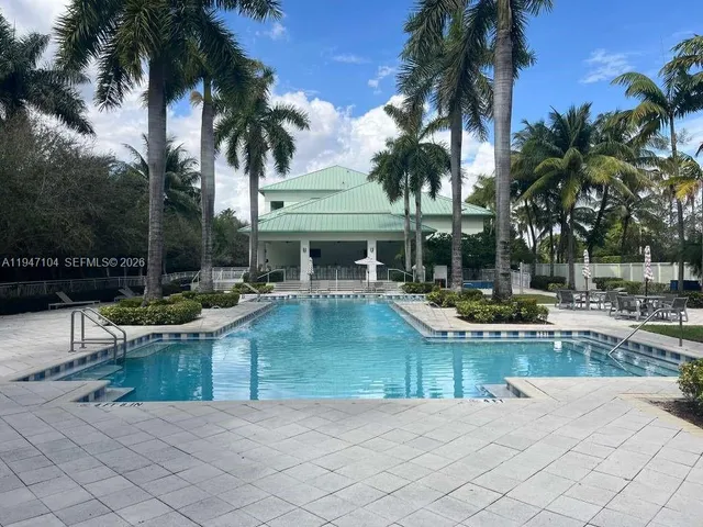 a view of a swimming pool with a table and chairs