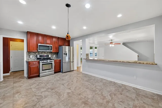 a large kitchen with stainless steel appliances kitchen island a large island in the center