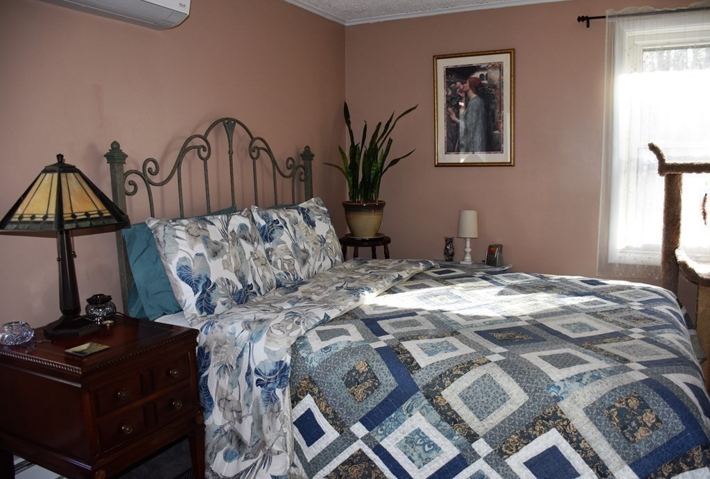 23 Bernie Road Holland, MA 01521 - Photo 14 of 36 a bed sitting in a bedroom next to a window