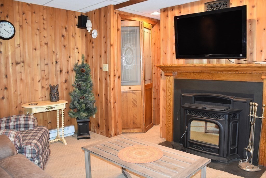 23 Bernie Road Holland, MA 01521 - Photo 17 of 36 a living room with a fireplace and a flat screen tv