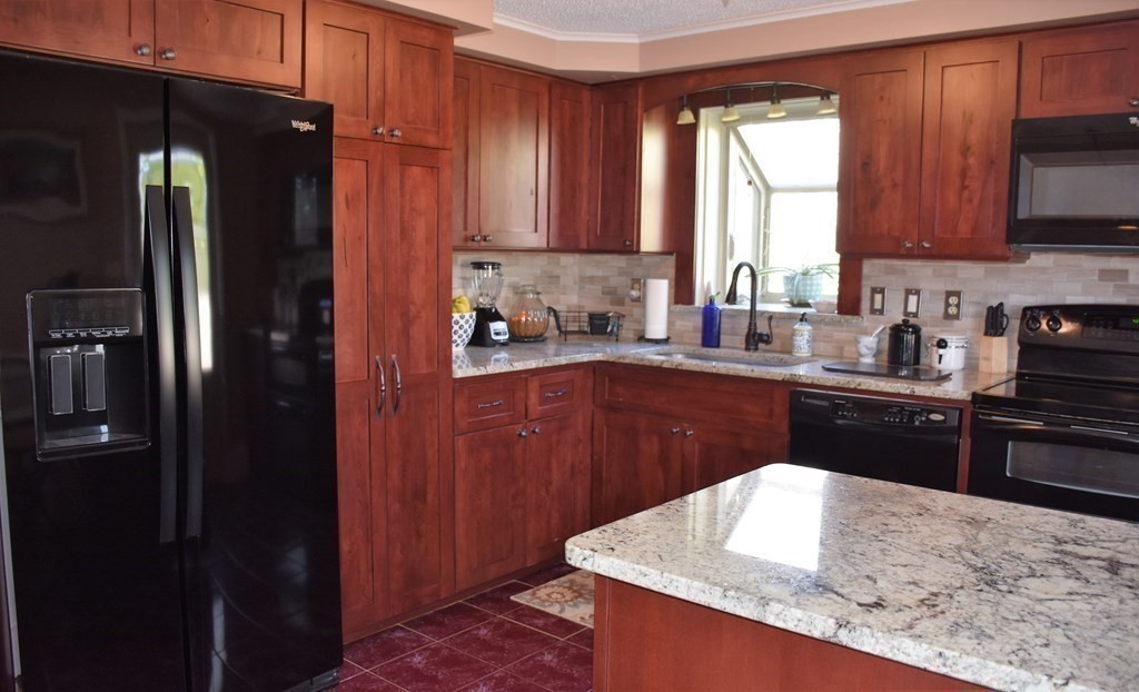 23 Bernie Road Holland, MA 01521 - Photo 9 of 36 a kitchen with a sink a stove and refrigerator