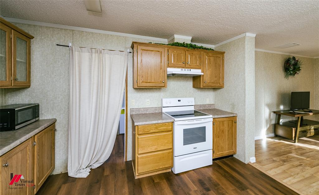 259 Kings Circle Grand Cane, LA 71032 - Photo 19 of 38 a kitchen with a stove and wooden floor