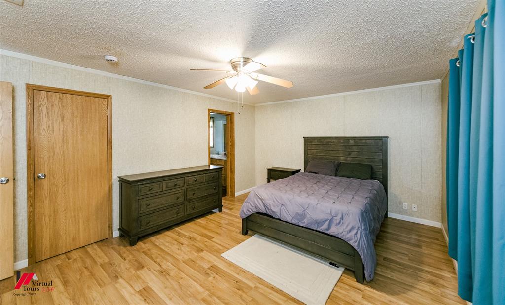 259 Kings Circle Grand Cane, LA 71032 - Photo 21 of 38 a bedroom with a bed and a dresser