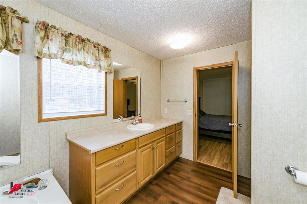 259 Kings Circle Grand Cane, LA 71032 - Photo 24 of 38 a bathroom with a sink and a mirror