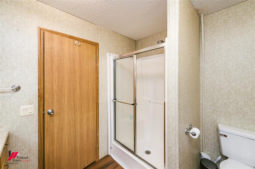 259 Kings Circle Grand Cane, LA 71032 - Photo 26 of 38 a bathroom with a shower and a toilet