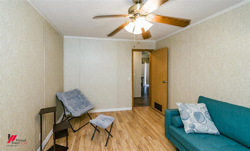 259 Kings Circle Grand Cane, LA 71032 - Photo 29 of 38 a bedroom with a bed and a chandelier fan