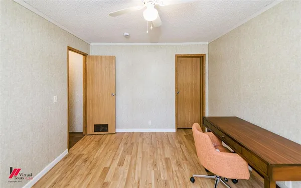 a view of a room with wooden floor and bedroom