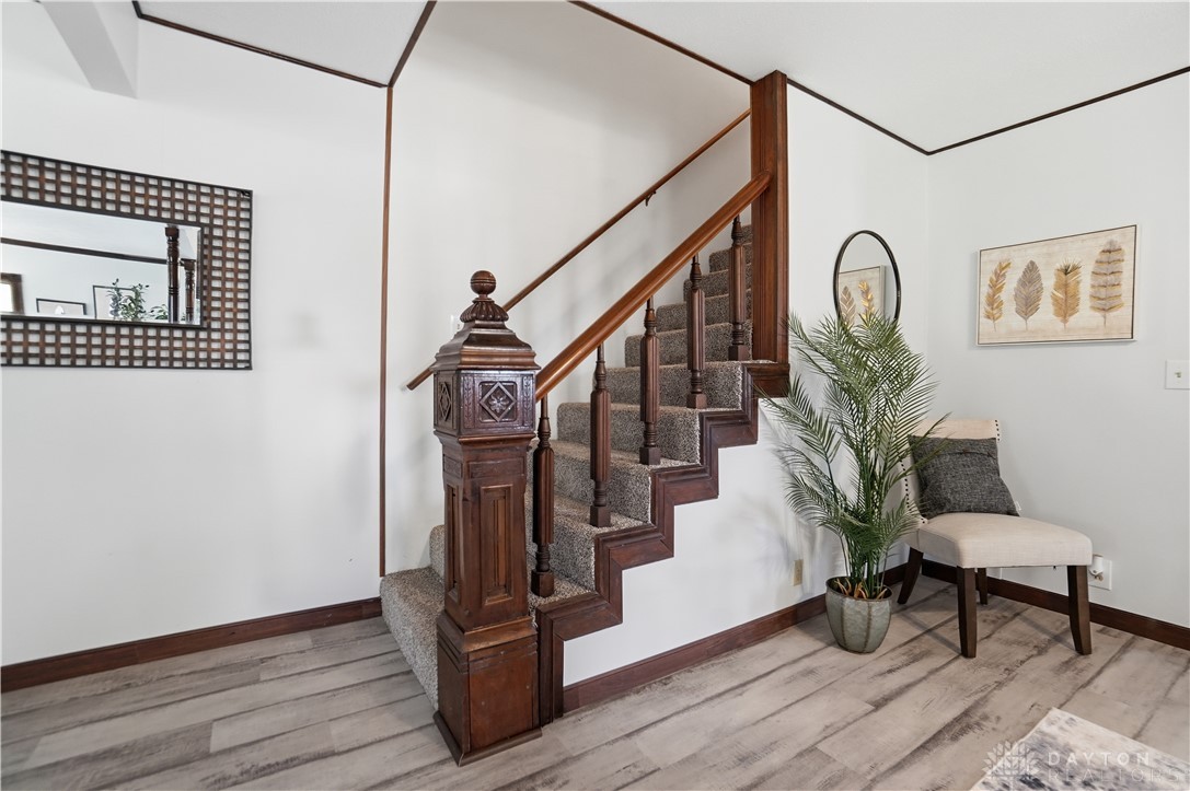 7553 Coffin Station Road Springfield, OH 45502 - Photo 31 of 95 This interior staircase features elegant wooden balusters and comfortable carpeted steps, ideal for easy transitions.