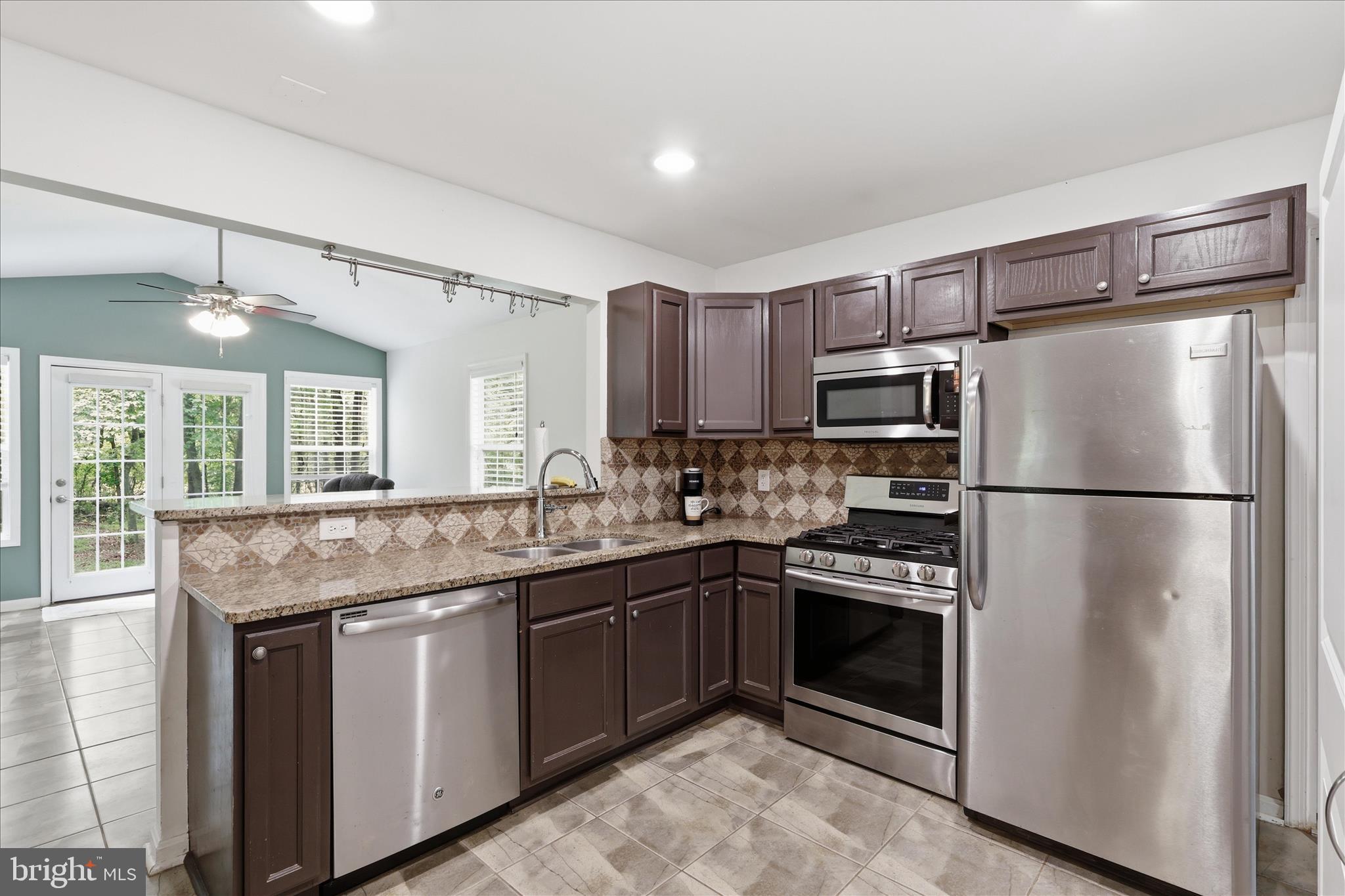 515 Shelton Shop Road Stafford, VA 22554 - Photo 15 of 52 a kitchen with kitchen island granite countertop stainless steel appliances and sink