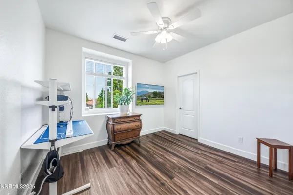a work room with wooden floor and windows