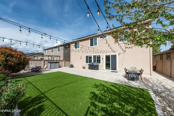 a view of a patio with a table chairs and a backyard