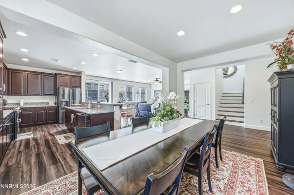 a kitchen with kitchen island granite countertop wooden cabinets and white appliances