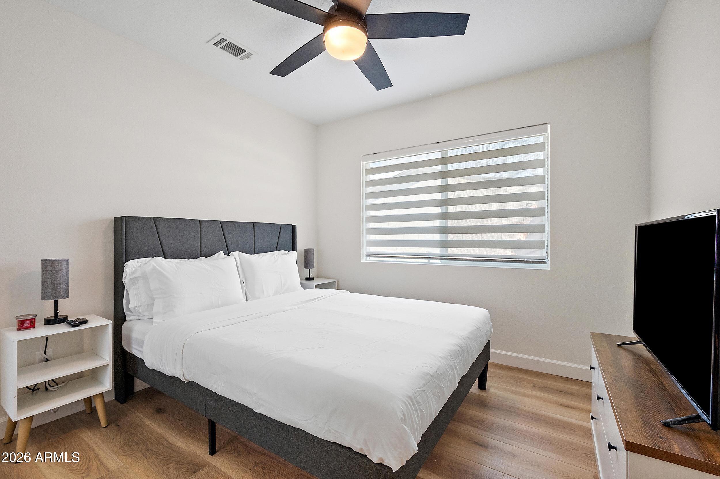 3911 North 13th Way Phoenix, AZ 85014 - Photo 11 of 34 a bedroom with a bed and a flat screen tv