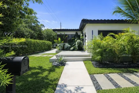 a front view of a house with garden