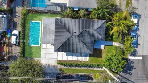 a view of backyard with swimming pool and outdoor seating
