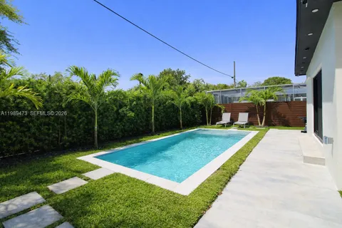 a view of a backyard with a small pool