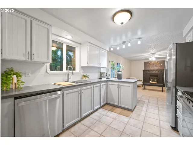 a kitchen with a sink cabinets and window