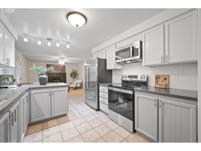 a kitchen with stainless steel appliances granite countertop a sink and cabinets