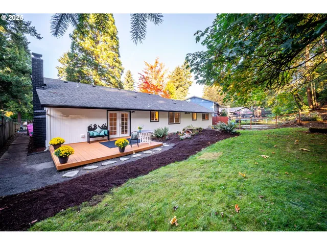 a view of a house with backyard and sitting area