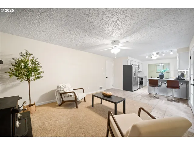 a view of livingroom with furniture and a potted plant