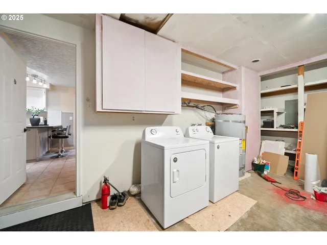a utility room with cabinets dryer and washer