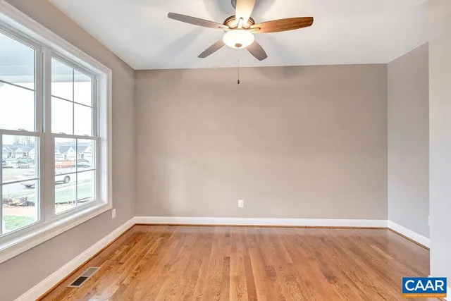 a view of a room with wooden floor and windows