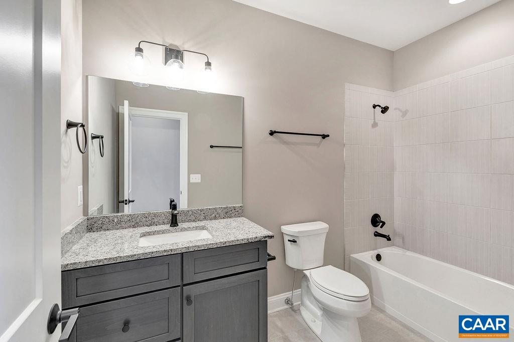3 B Lonicera Way Charlottesville, VA 22911 - Photo 18 of 22 a bathroom with a granite countertop toilet a sink and a mirror