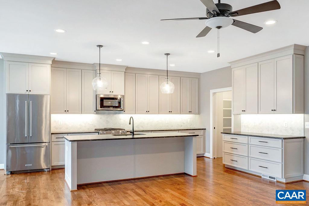 3 B Lonicera Way Charlottesville, VA 22911 - Photo 2 of 22 a kitchen with kitchen island white cabinets and stainless steel appliances