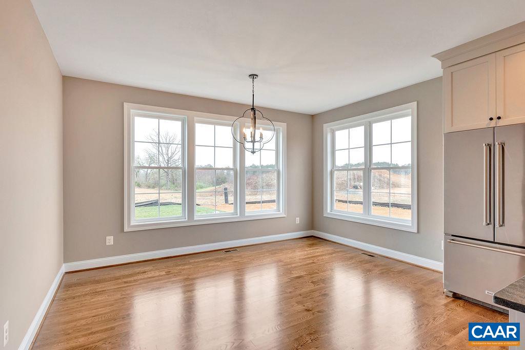 3 B Lonicera Way Charlottesville, VA 22911 - Photo 6 of 22 a view of an empty room with a window and wooden floor