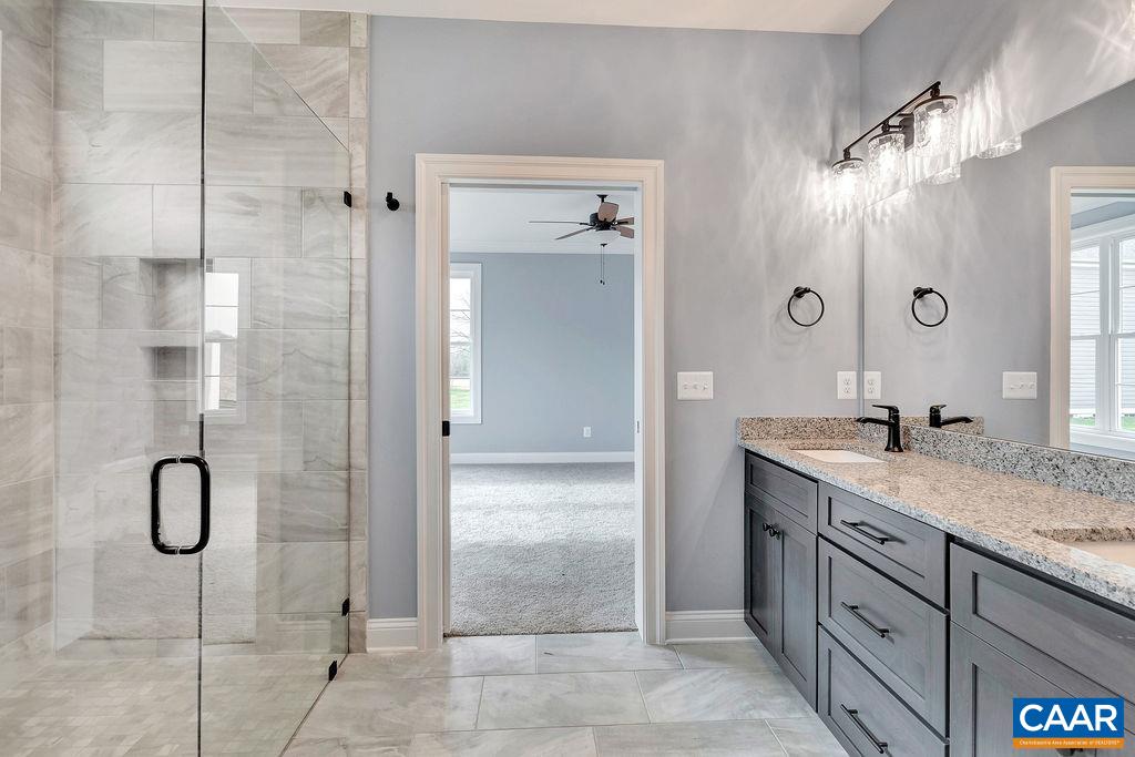 3 B Lonicera Way Charlottesville, VA 22911 - Photo 9 of 22 a bathroom with a granite countertop sink a shower and a mirror