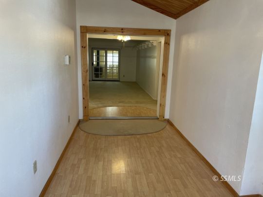 337 Peg Street Ridgecrest, CA 93555 - Photo 3 of 33 a view of a hallway with wooden floor