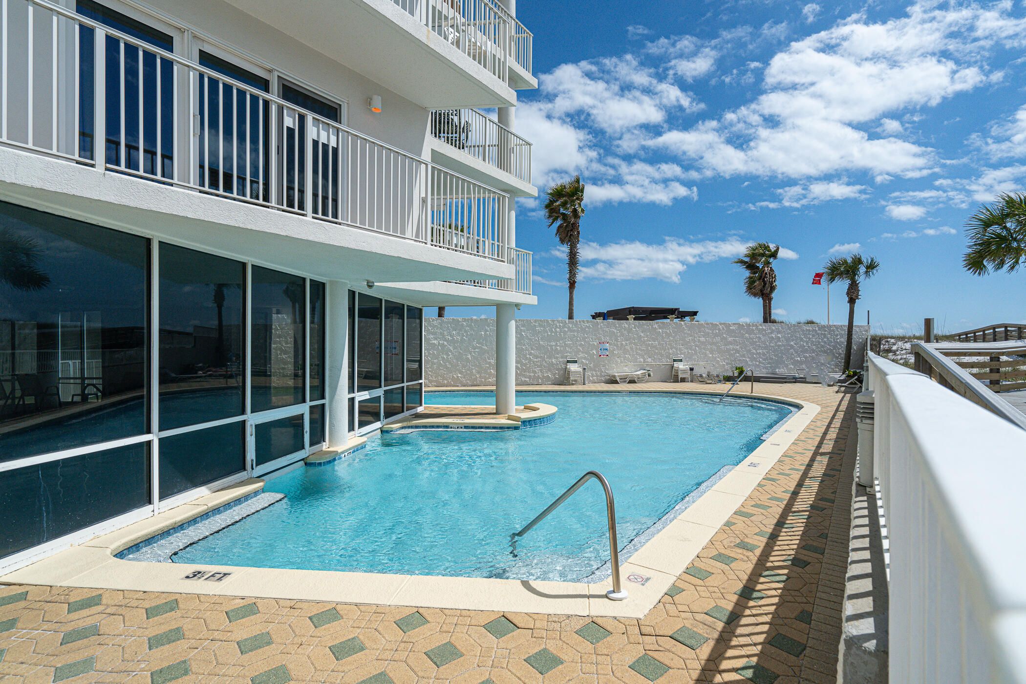 895 Santa Rosa Boulevard, Unit 308 Fort Walton Beach, FL 32548 - Photo 1 of 31 a view of a swimming pool with a lounge chairs
